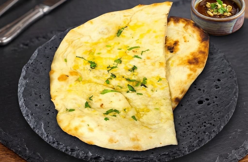 Chef's Special Garlic Naan brushed with butter and herbs, served with dipping sauce