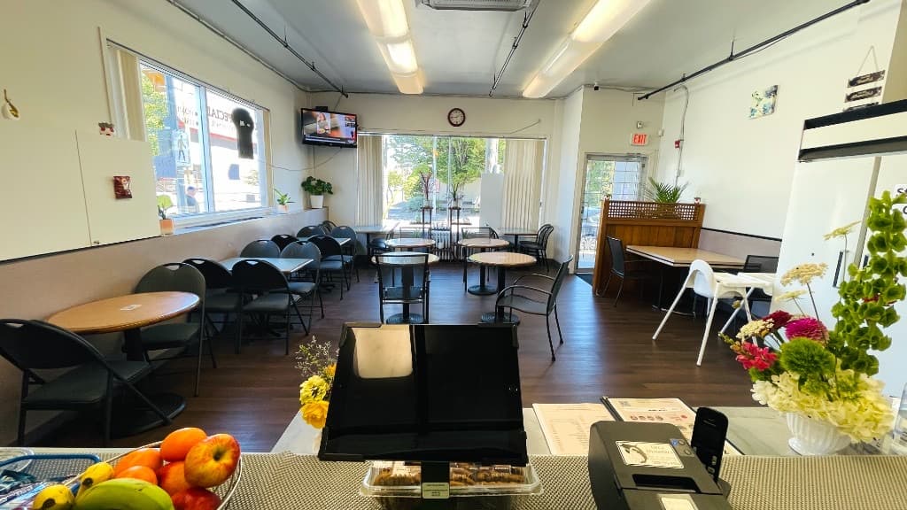 Zaika restaurant dining room in Victoria, BC — bright tables, natural light, and a welcoming casual interior
